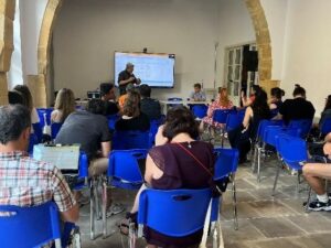 Photo shows Mr Alexandros Michaelides sharing his story as employer to the audience.