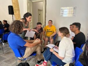 Photo shows Mrs Antonia Tziannarou explaining an exercise to a group of participants