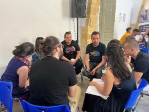 Photo shows a group of participants collaborating to complete a task.